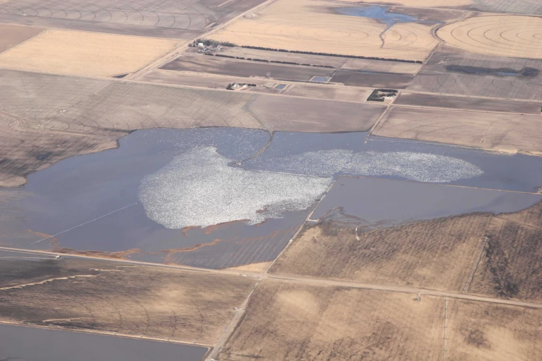 the flooded farmland is shown from a small air plane