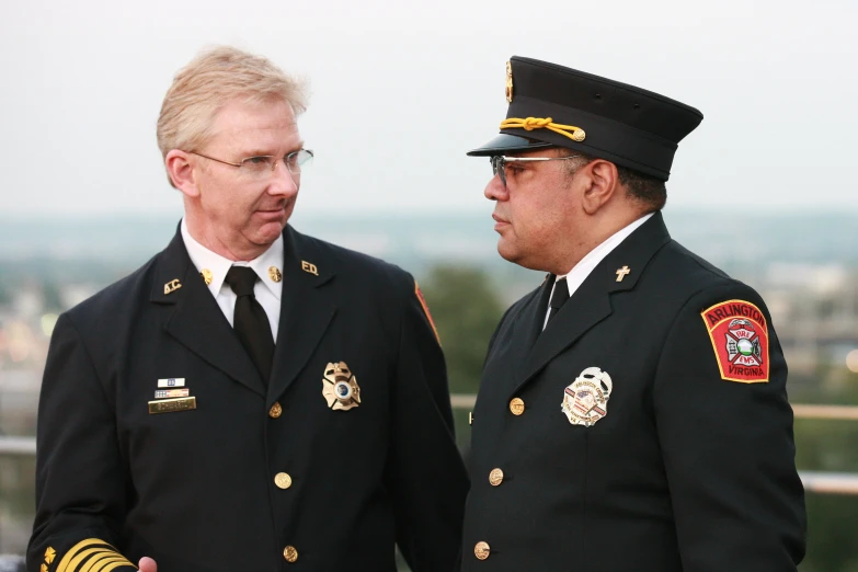 two uniformed men in uniform talking together