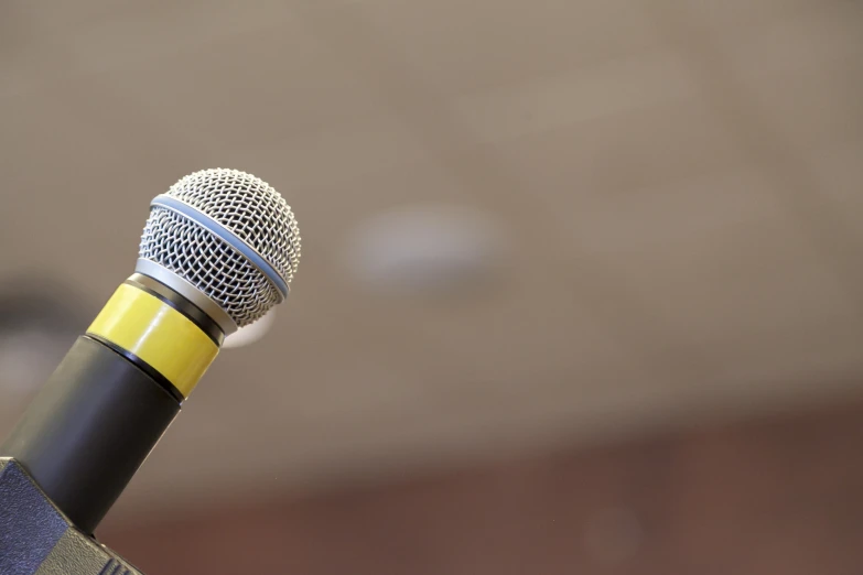 the top of a black and yellow microphone