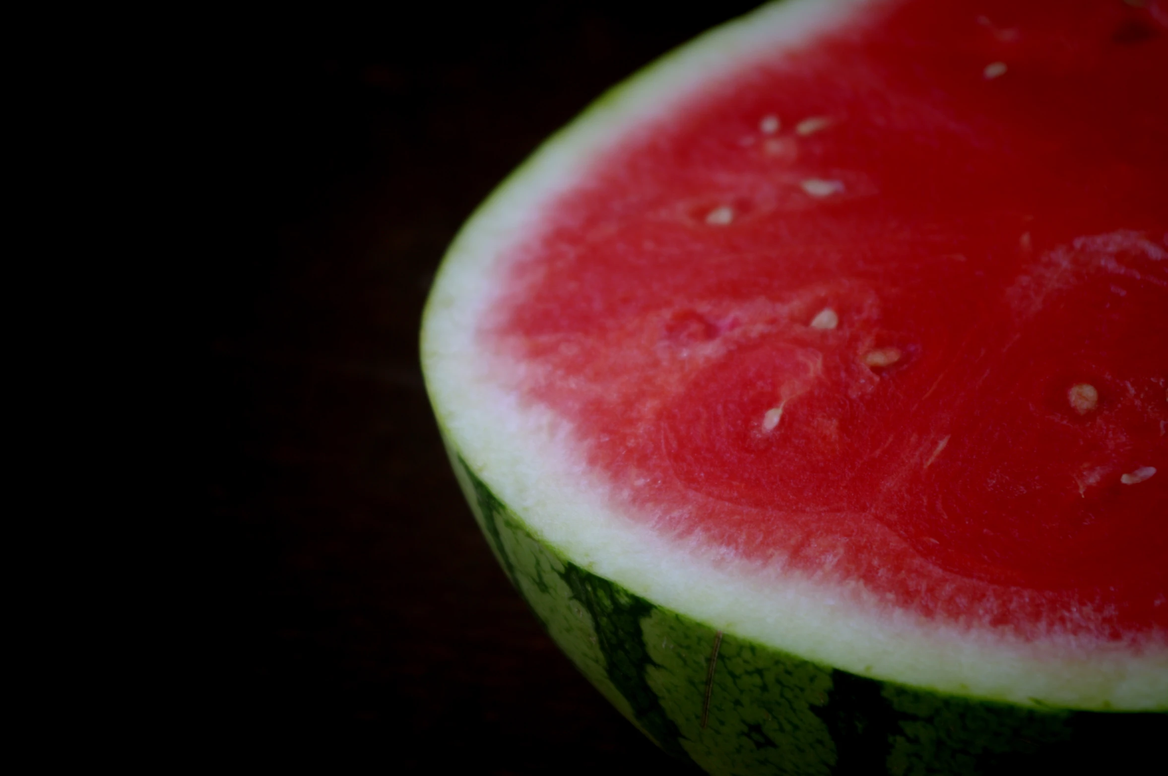 a big slice of watermelon on a dark background