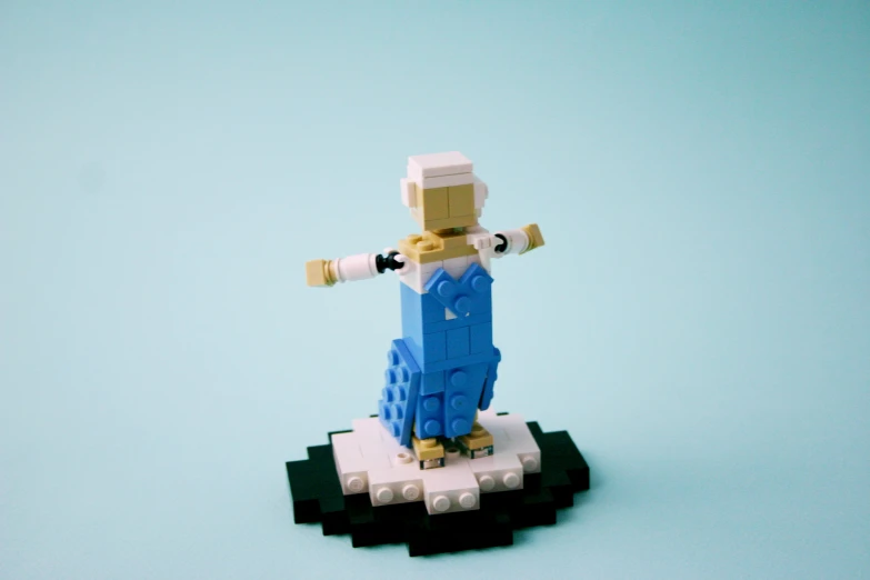 a lego person on a tiny rock holding a wrench