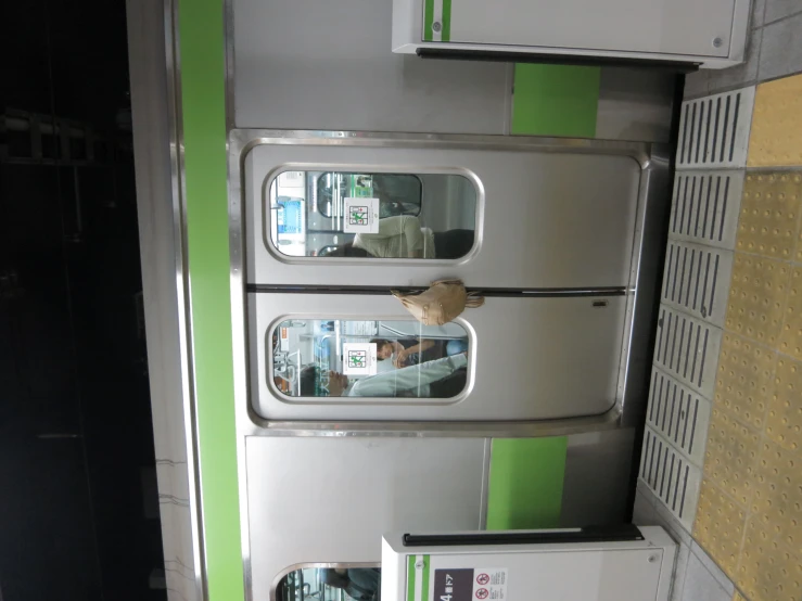 the passengers are sitting inside a subway train