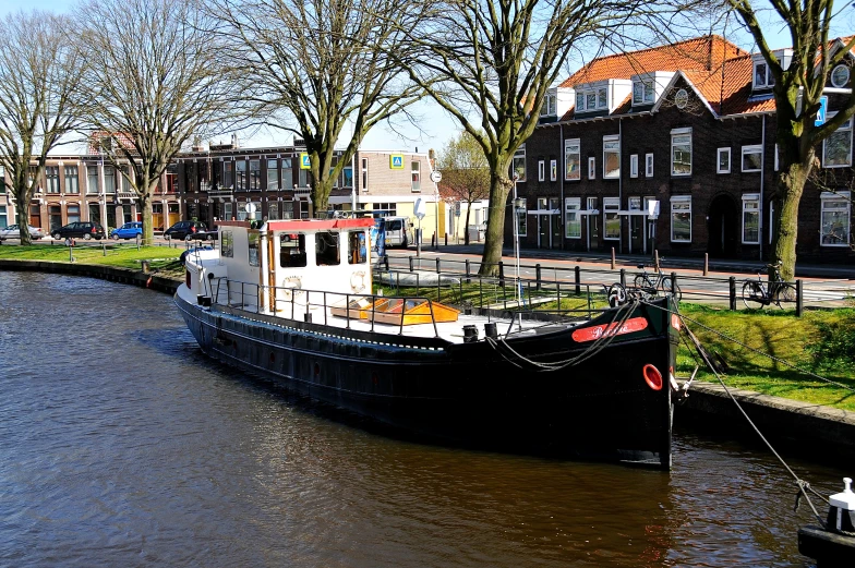 a house boat is docked in a channel