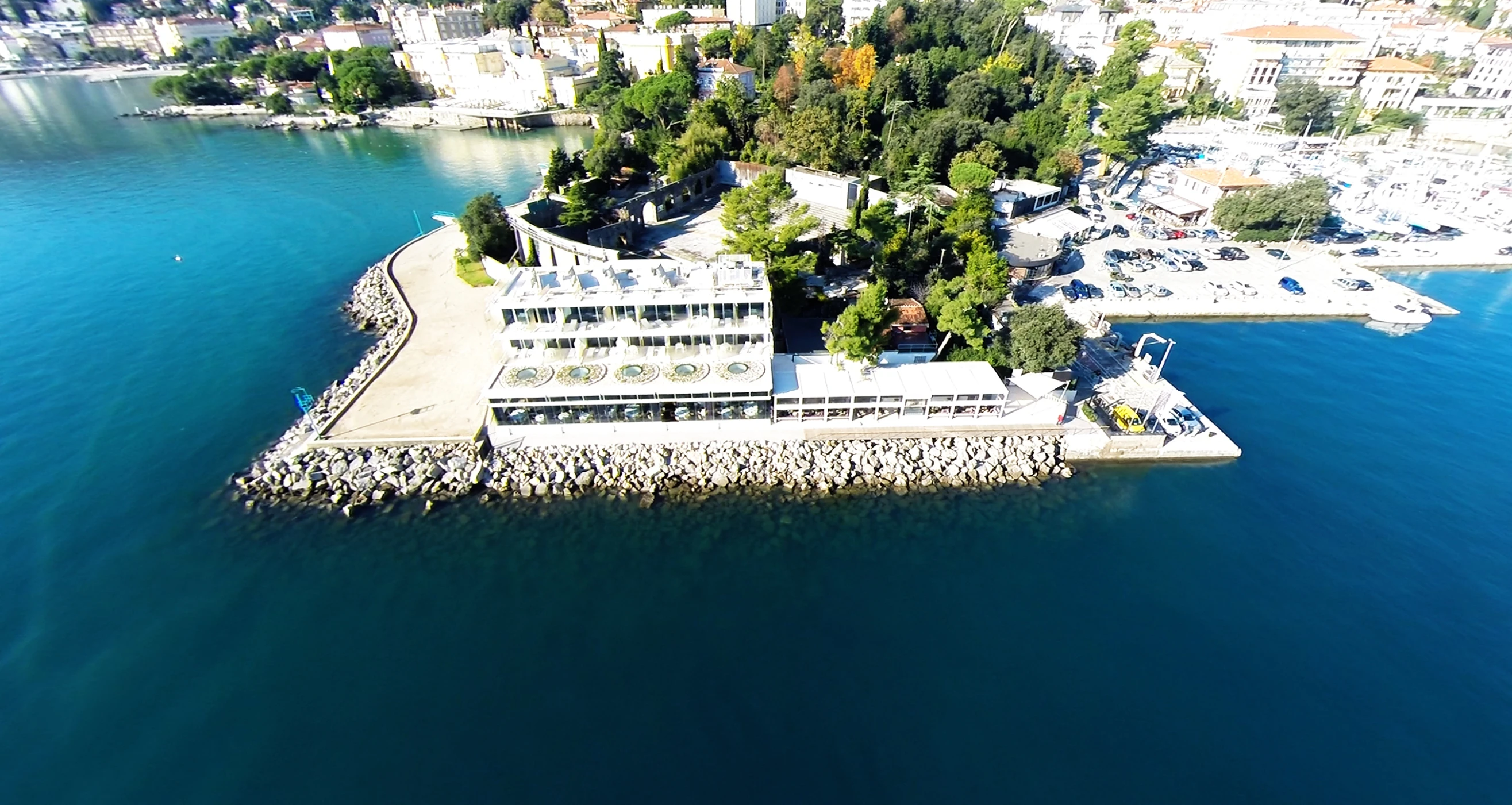 an aerial view of the sea and a building