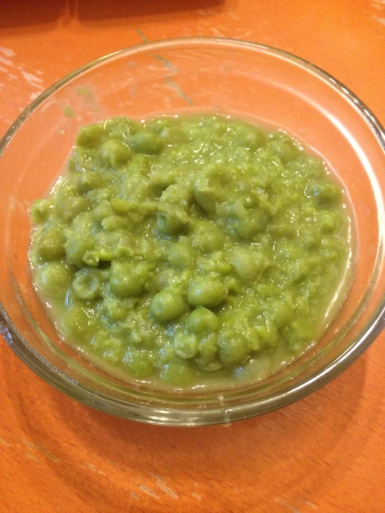 a bowl on the table filled with some kind of green condiment