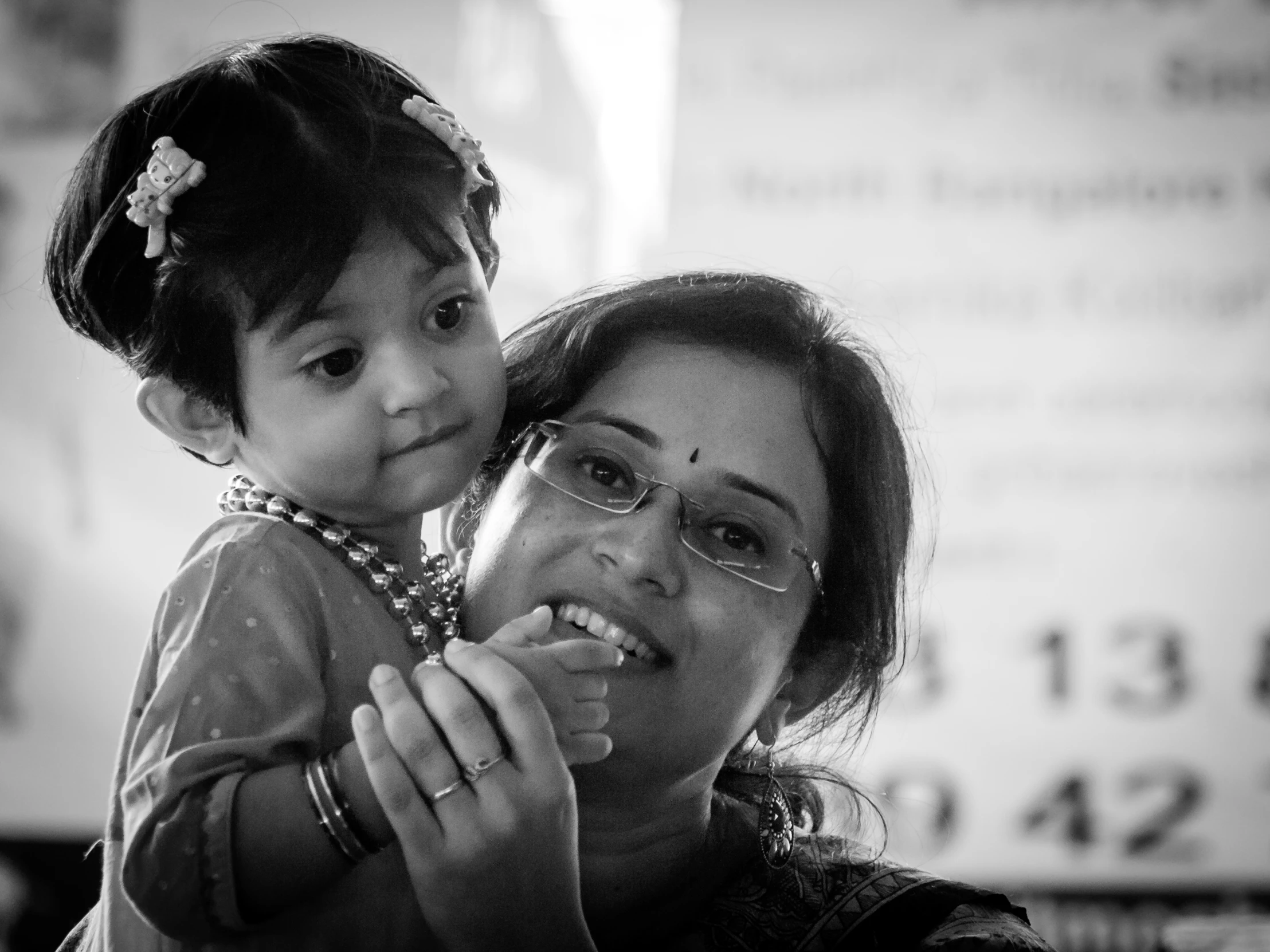 woman holding a little girl and making an odd face