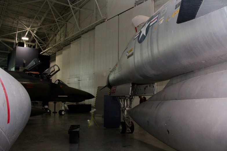 several military aircraft are shown inside a hangar