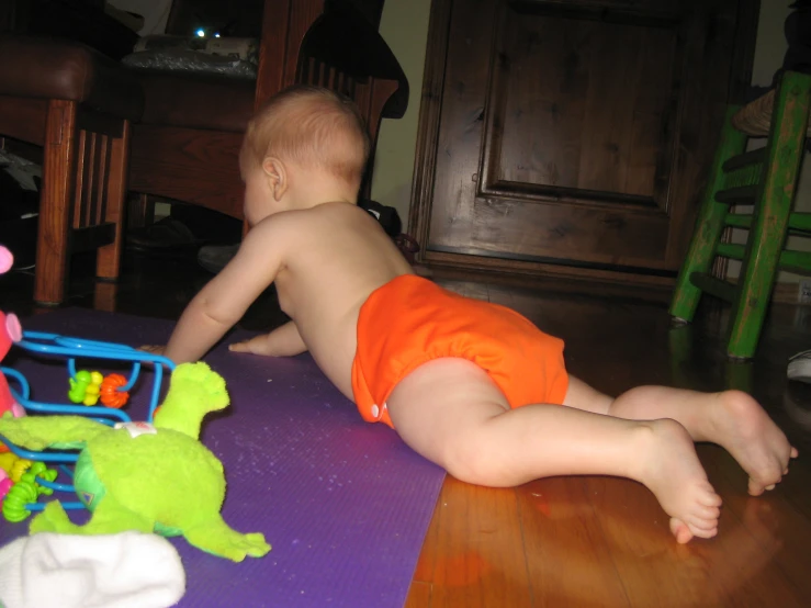 baby playing with toys on the floor of a room