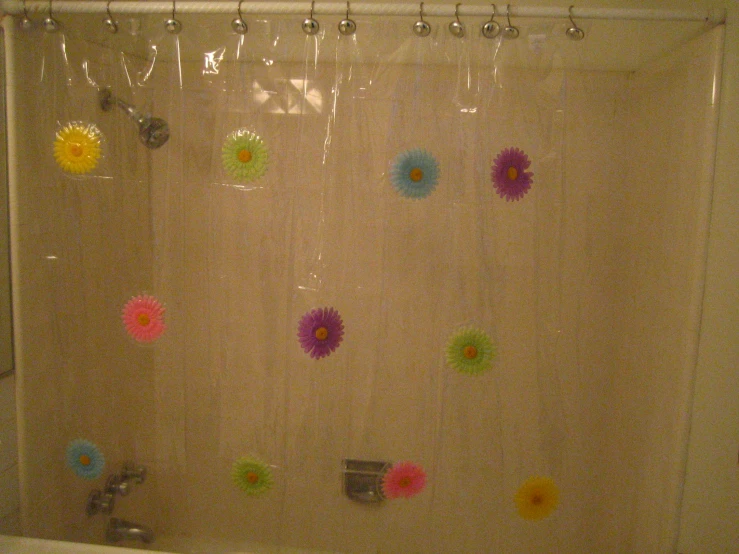 some colorful flowers hanging on the shower curtain