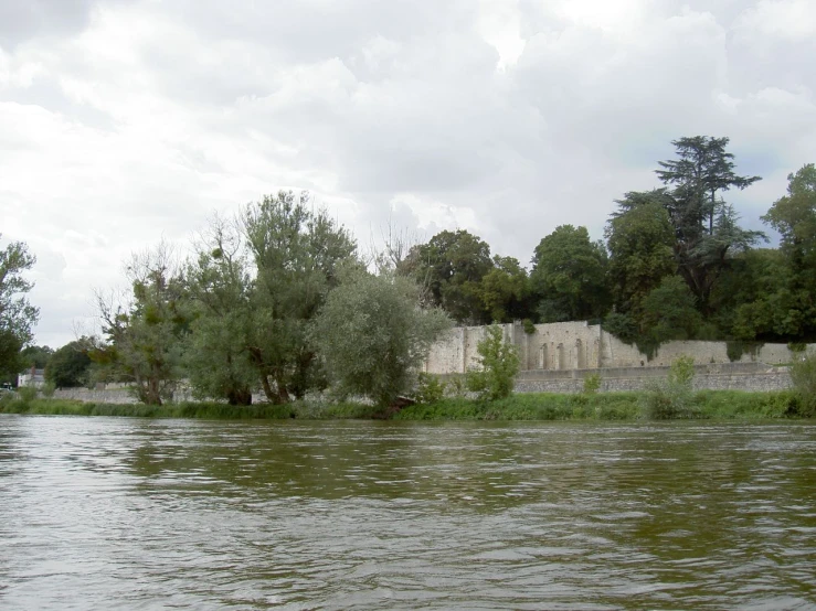 a body of water surrounded by trees and walls