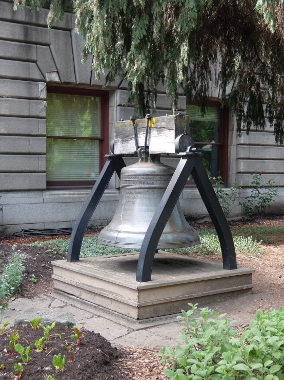 the large bell is near the building