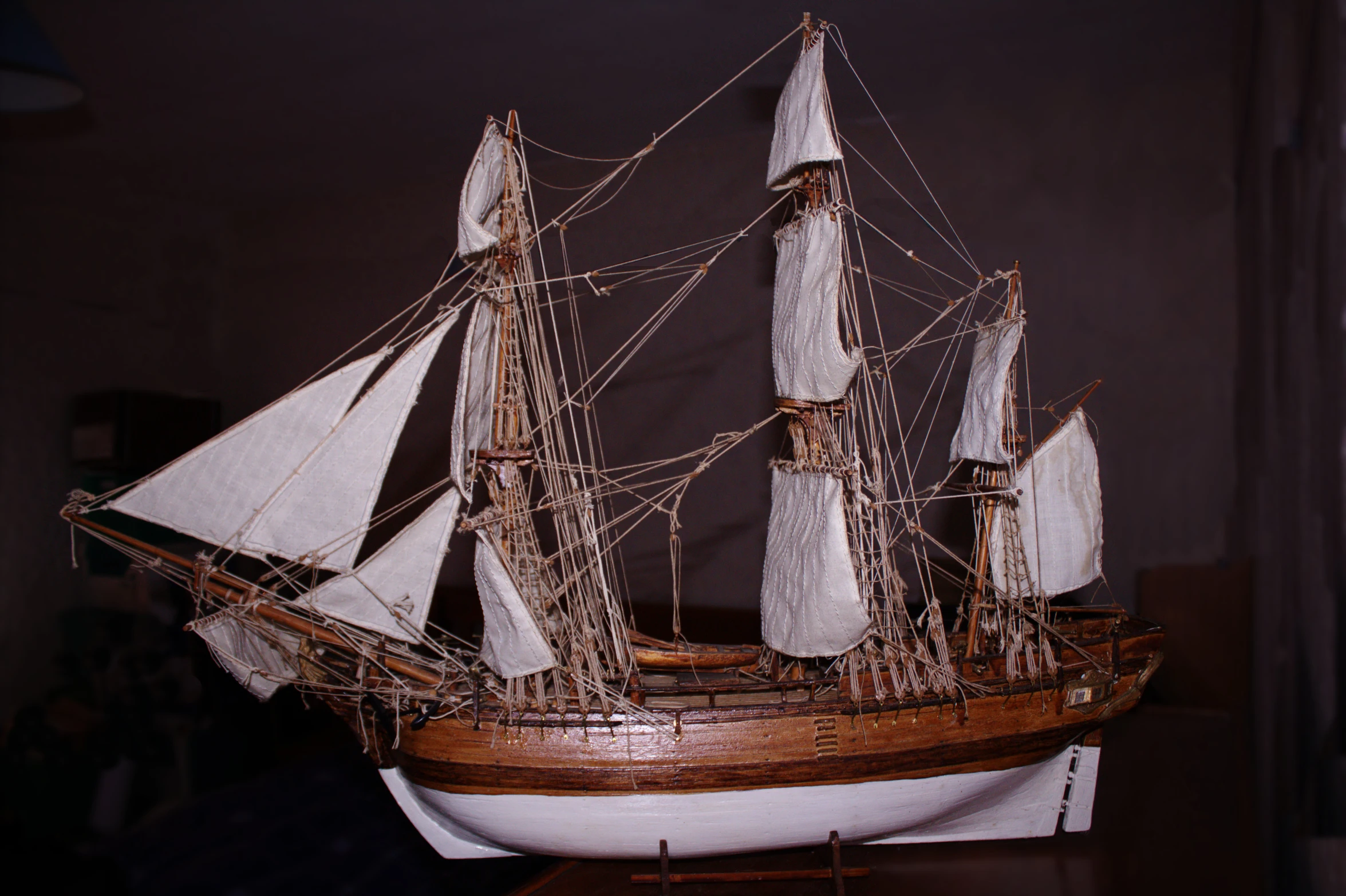 a small sailboat model made of wood