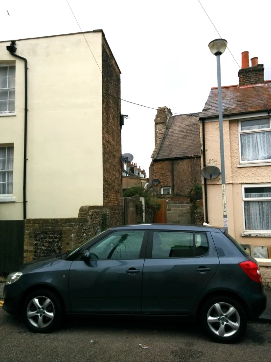 an image of a black car parked in front of a house