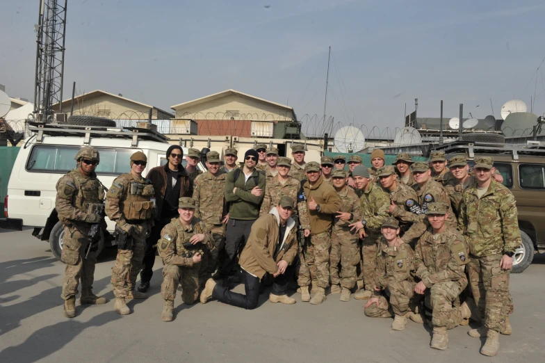 men in military gear posing for a group po