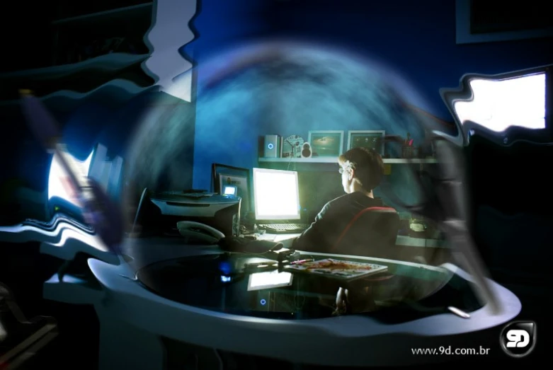 an artistic po of a man sitting at his desk in front of a computer screen