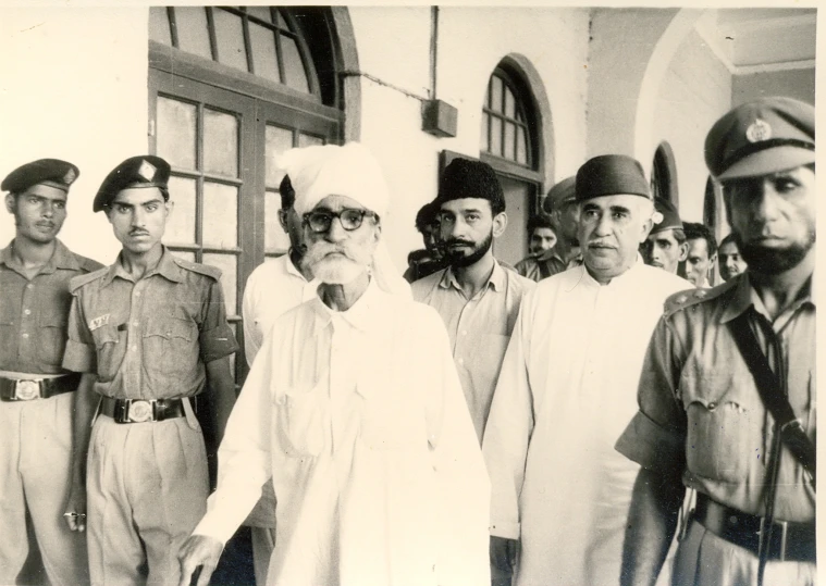 an old black and white po of people in uniform