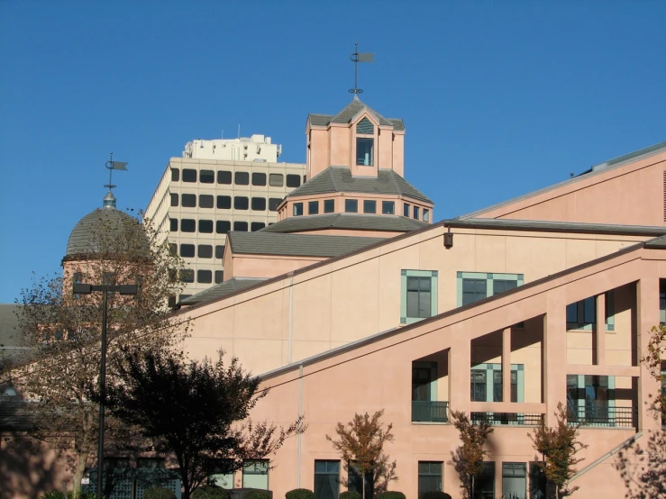 an office building sits in the background behind other buildings