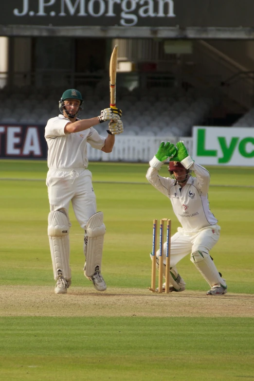 a group of men playing a game of cricket