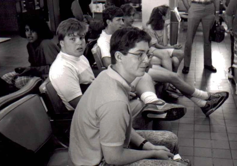 black and white pograph of a group of people in a train station