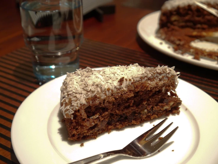 two white plates with slices of cake on them