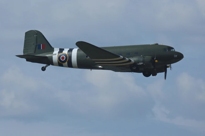 a gray airplane flying through a blue sky