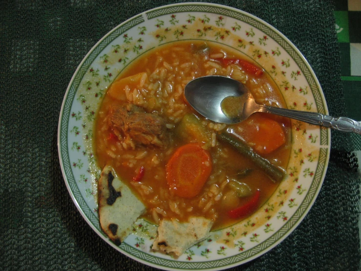 a bowl of soup with meat and vegetables