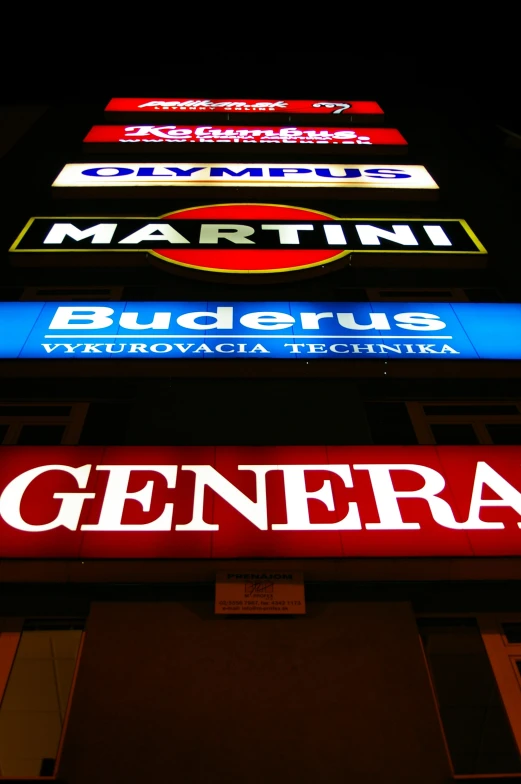 lit signs in multiple languages and lit up at night