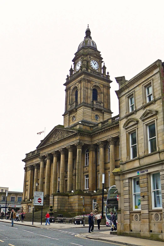 a large building with a clock in the top of it's tower