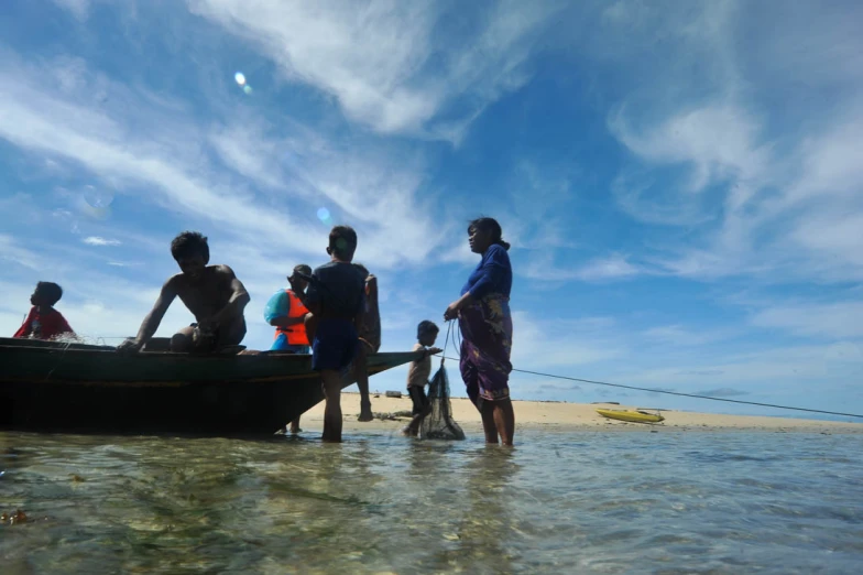 four people and their small boat in the water