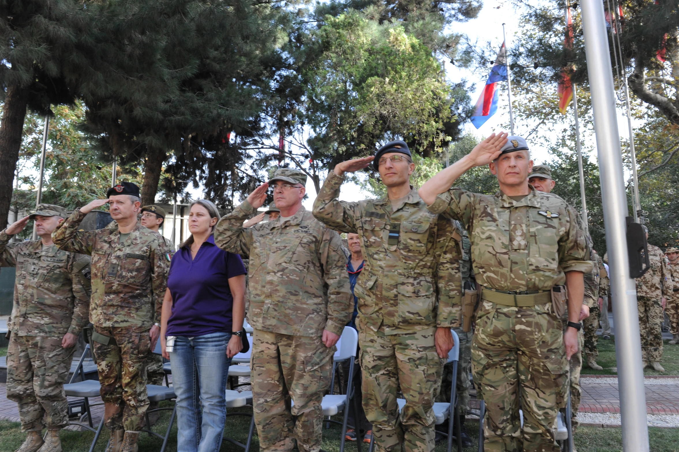 military personnel salutes the flag and salutes them