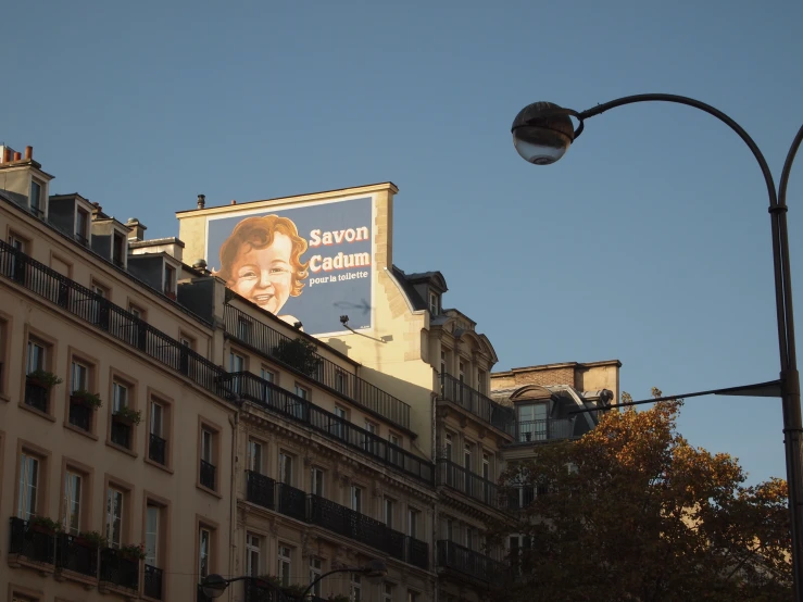 the billboard for a president is seen on an apartment building