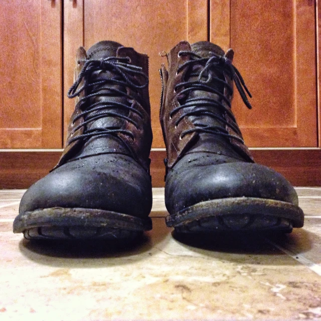 a brown pair of boots are sitting on the ground