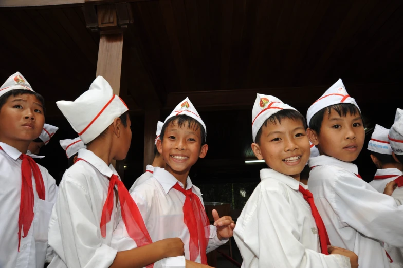 a group of children wearing white uniforms