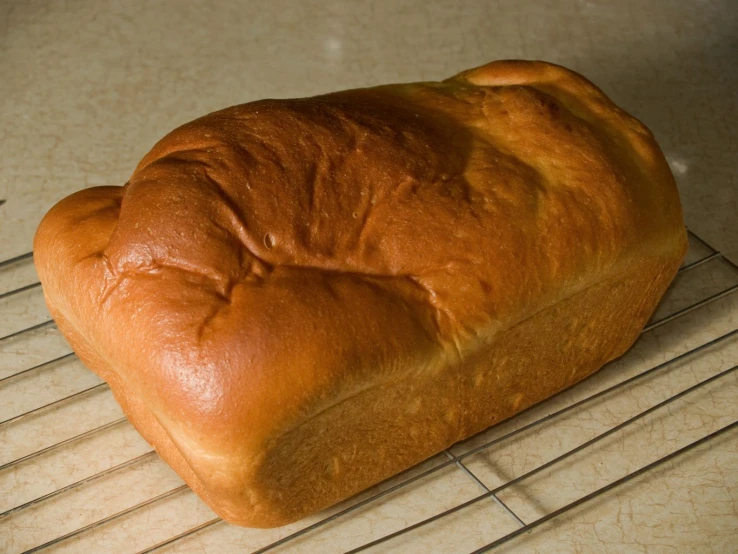 some very delicious looking bread that is on a cooling rack