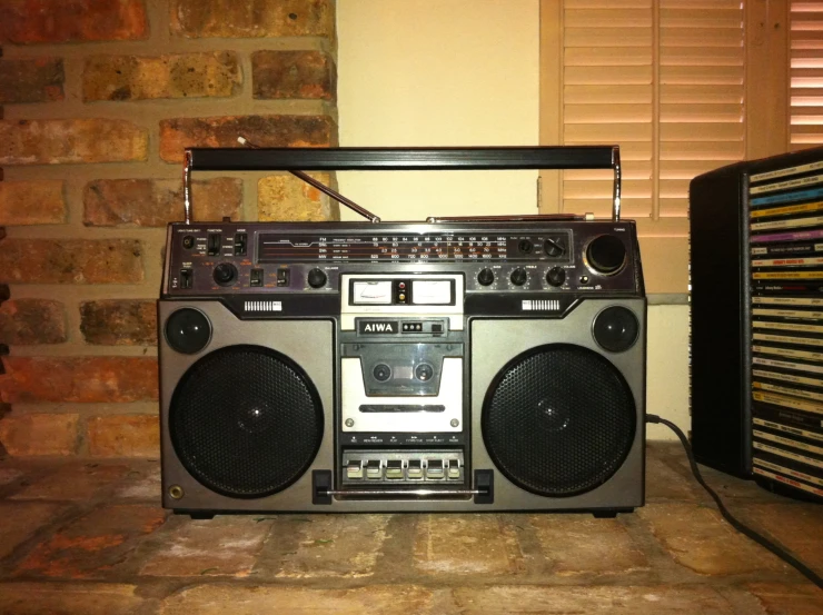 a stereo on a counter with a brick wall in the background