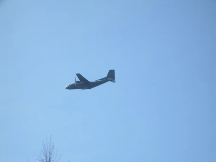 an airplane flying thru the sky on a clear day