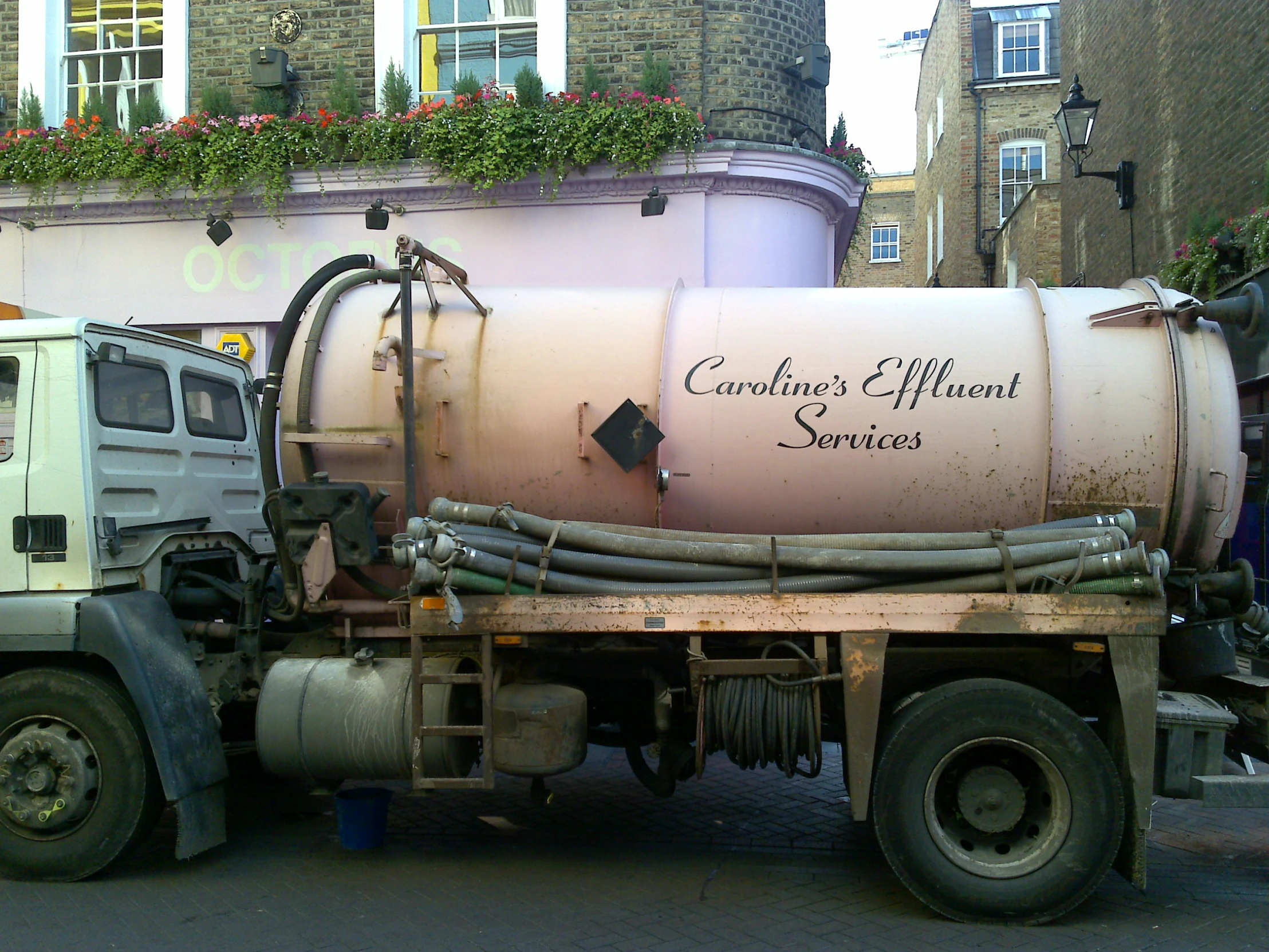 a water truck is parked in front of a building