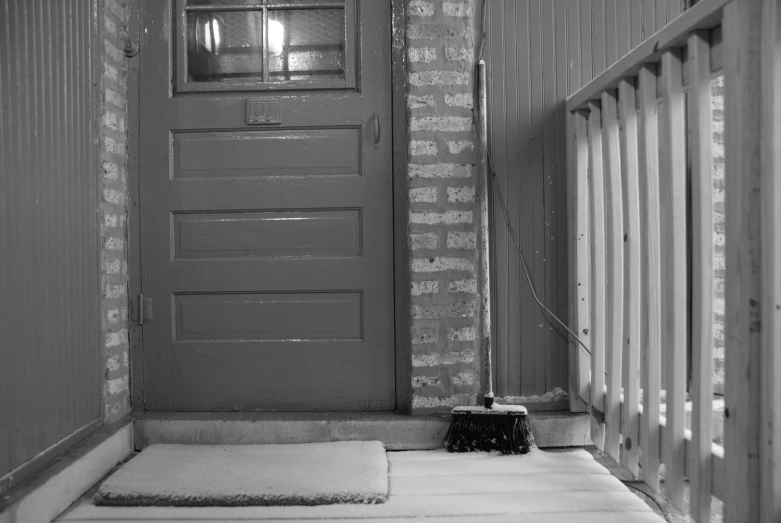 the door to a house with an entry mat next to it