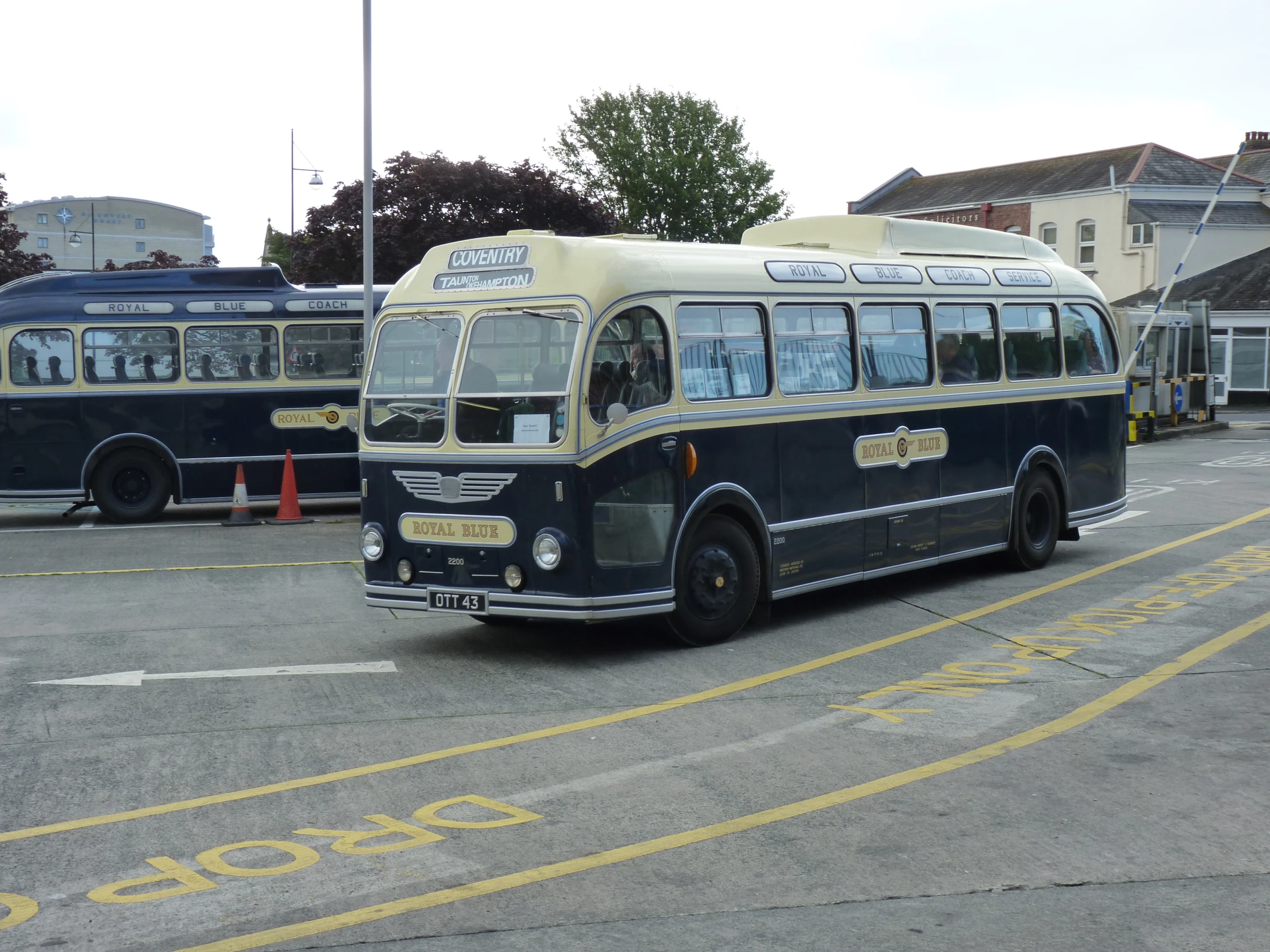 there are several buses parked at the bus depot