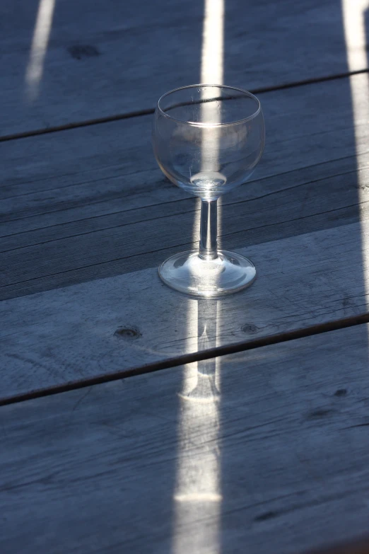 a glass sitting on top of a wooden table