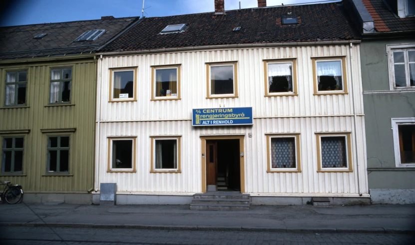 a white building with windows and a sign on it's front