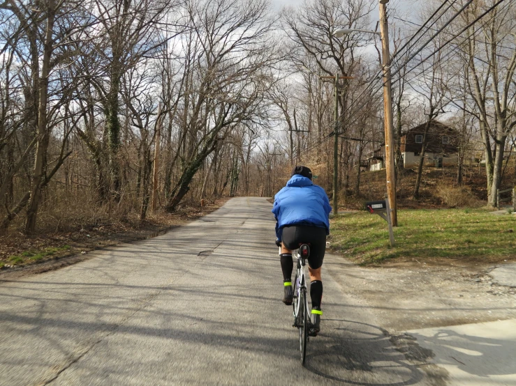 a person riding their bike down a small paved road