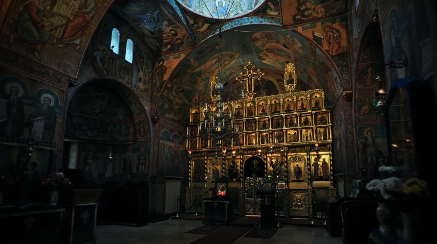 the altar in the church has an ornate painting on it