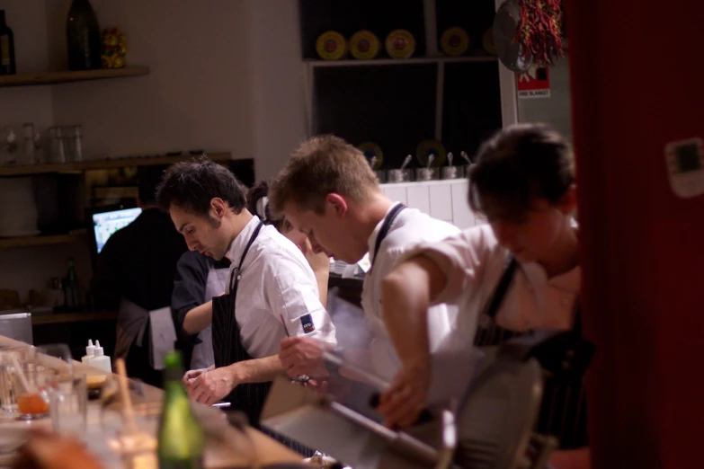 a group of people working in a restaurant kitchen