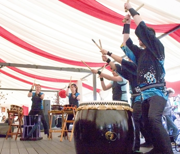 the young people are playing drums on stage