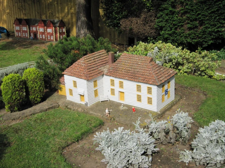 an aerial view of a model home next to a garden