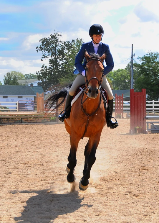 a person riding a horse across a dirt field