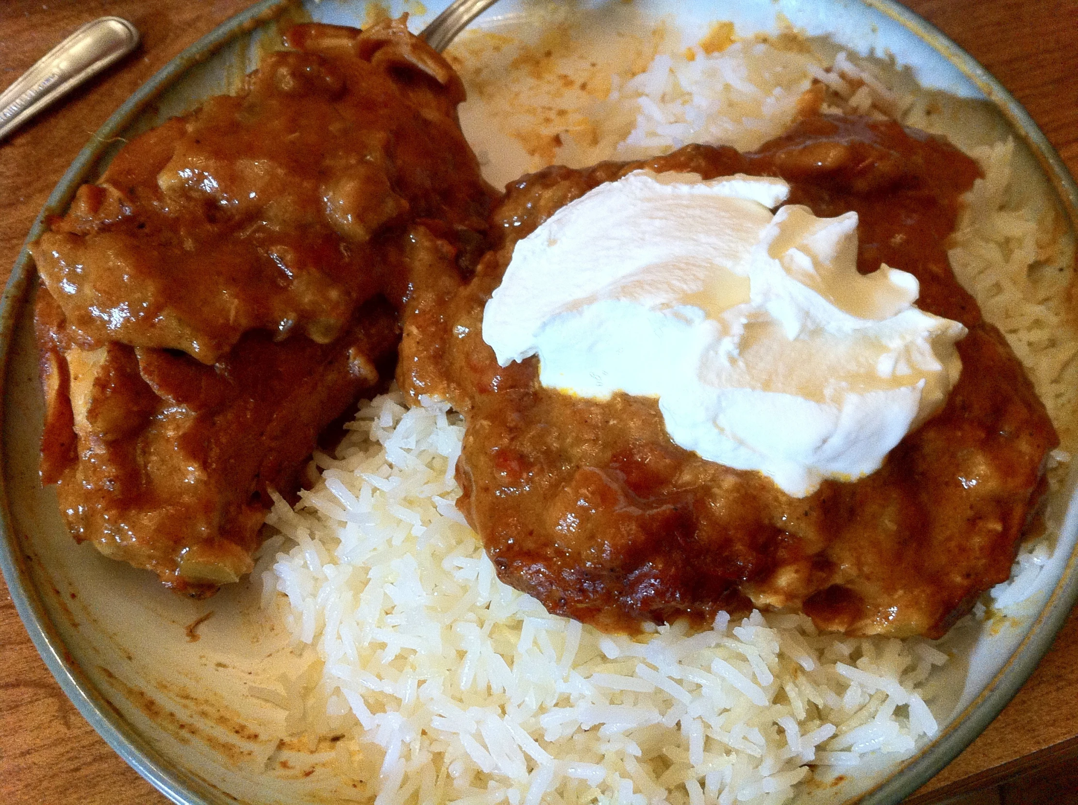 two meatballs and rice on a table