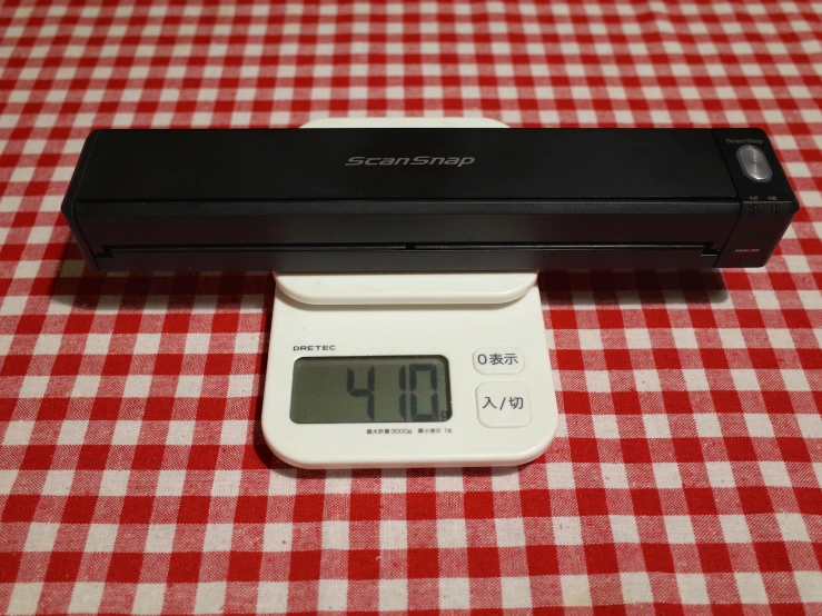 a digital scale that is laying on a table