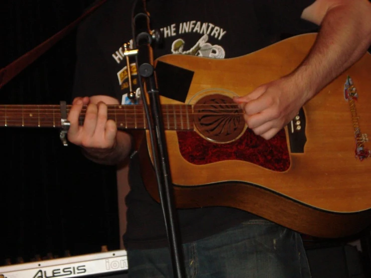 a man that is holding a guitar up